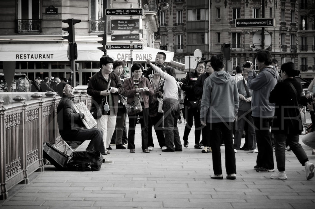 Paris Crowd around an Accordion Player near Notre Dame by Houston Commercial Architectural Photographer Dee Zunker 