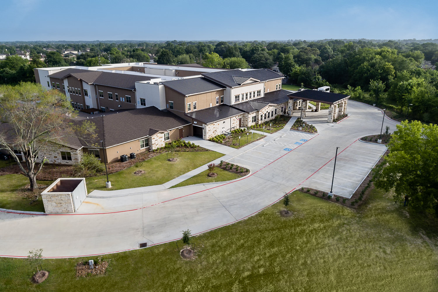Late afternoon drone view of a senior care center architecture in Northwest Houston, highlighting the facility grounds.