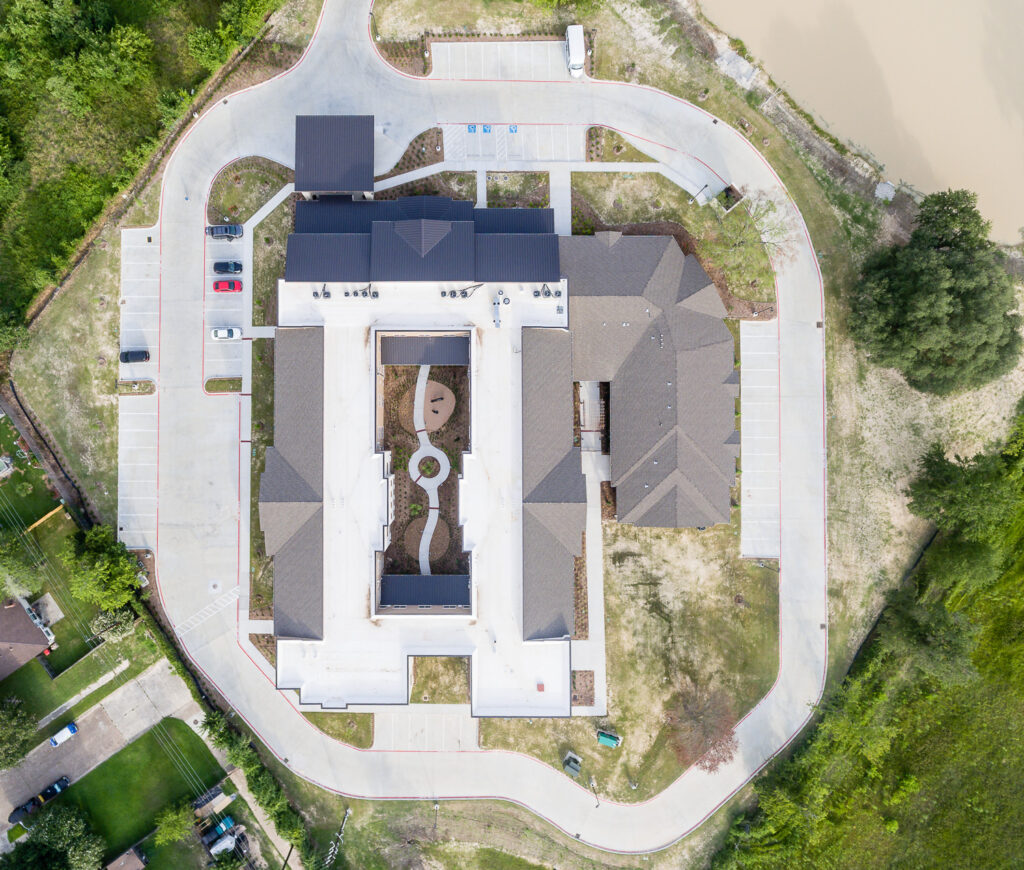 Overhead drone photo of an assisted living facility in Spring, TX, showing the building layout and grounds from above.