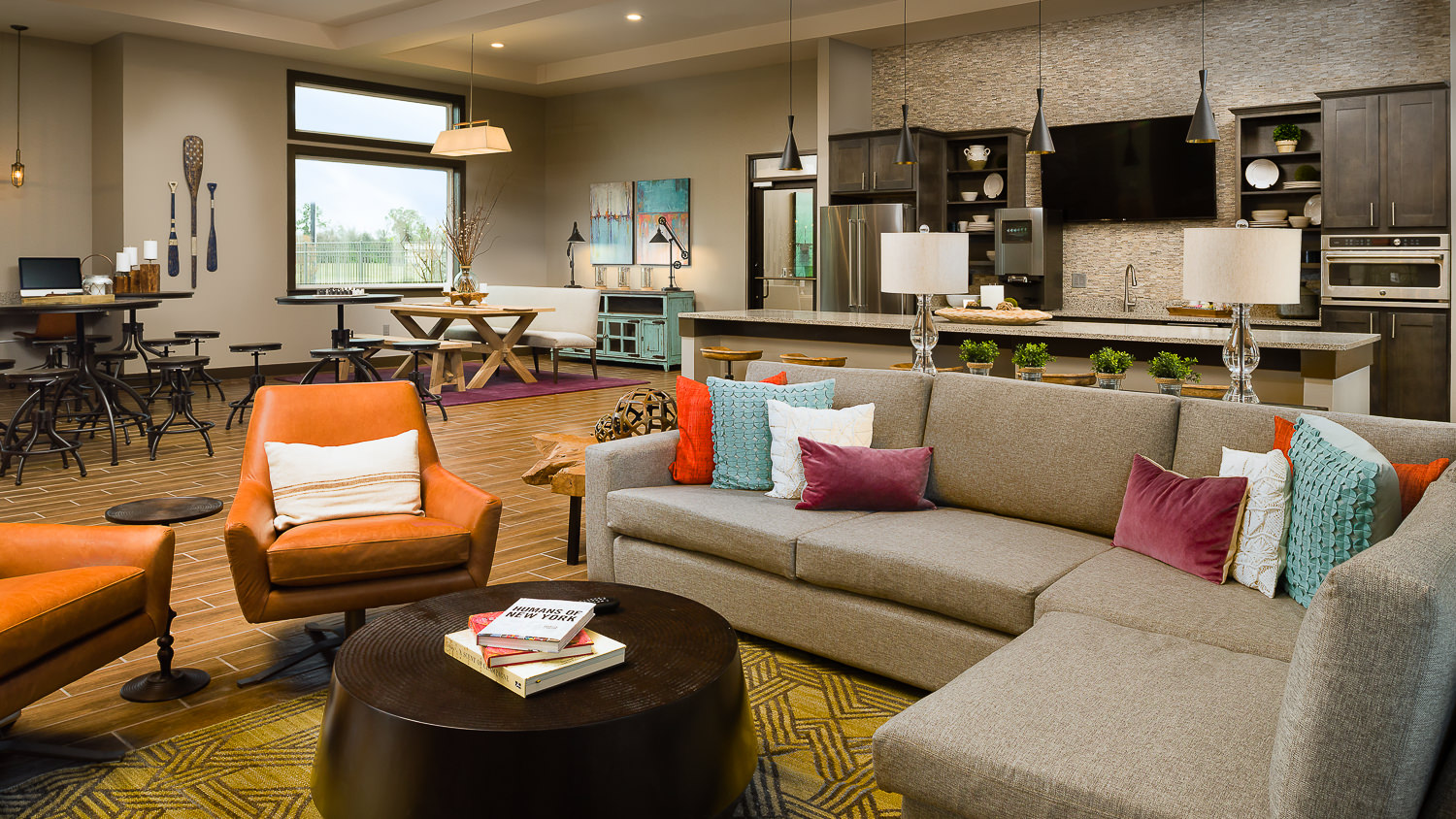 Interiors photo of a new Houston apartment complex community room, designed with a full kitchen, game area, and lounge space.