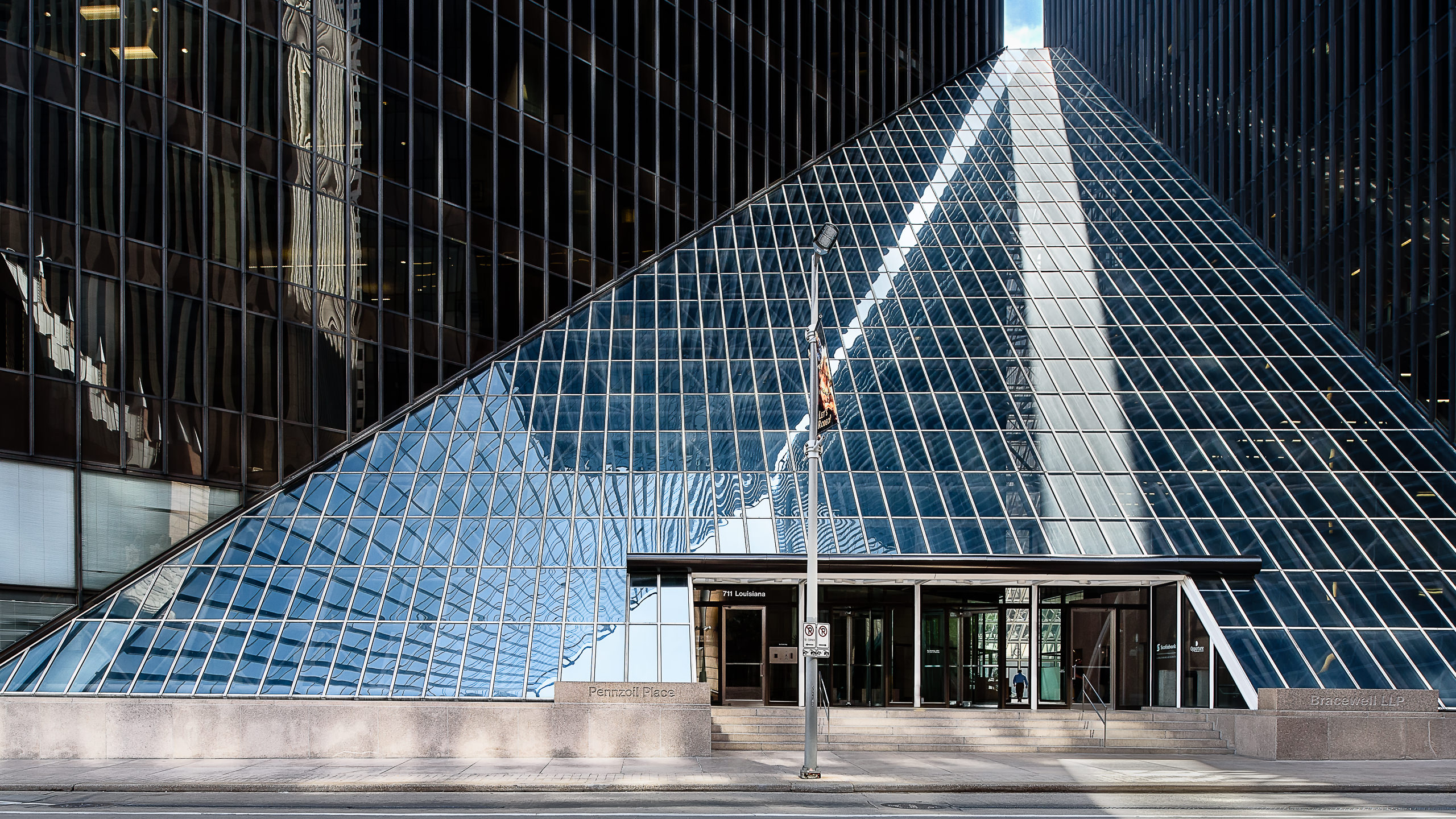Architectural photo of the iconic Pennzoil Place twin towers. This exterior shot highlights the dark glass of the Downtown Houston landmark.