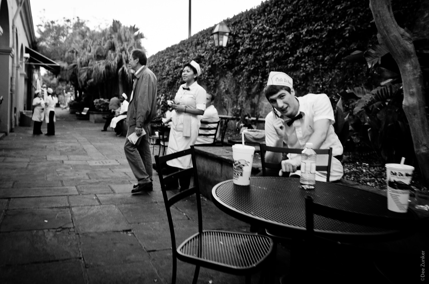 Waiter behind Cafe Du Monde New Orleans Street Photography by Houston Commercial Architectural Photographer Dee Zunker