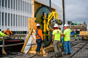 Construction workers prepare to lift a large skylight supplied by Glass Flooring Systems  into place on the roof of The Post in downtown Houston, TX