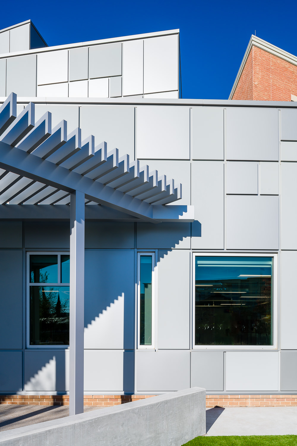 A close-up of the modern architectural details on the exterior metal panels of a new addition at River Oaks Baptist School.