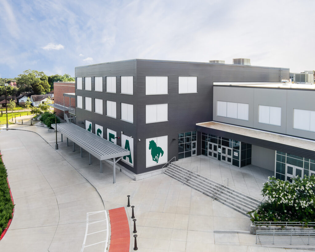 An aerial view showcasing the new addition attached to the historic campus of Stephen F. Austin High School in Houston, Texas.