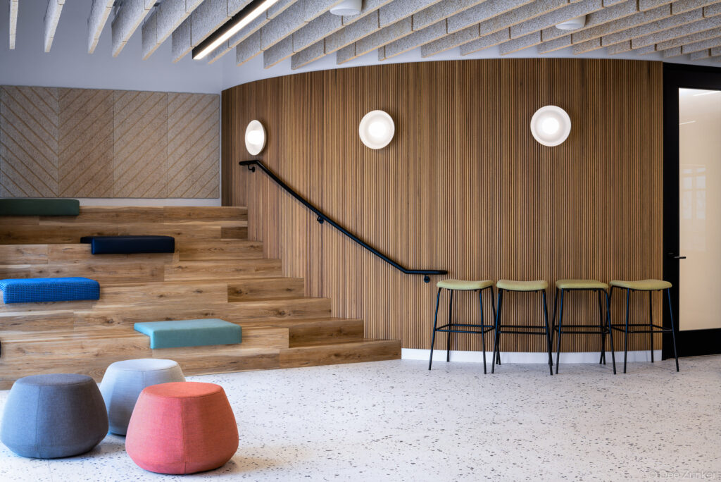 Architectural interior of a lecture area in Houston's Memorial, featuring tiered theatre seating designed with modern wood and metal tones.