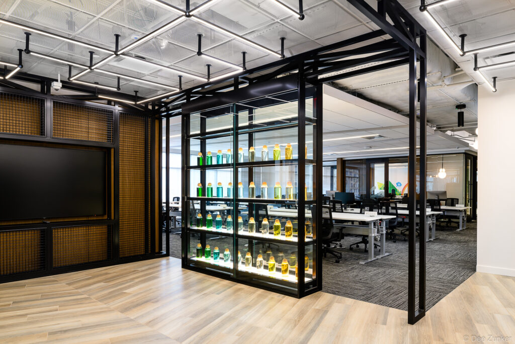 Architectural interior of the BP corporate office, showing a modern open space designed with black metal and warm wood trim elements.