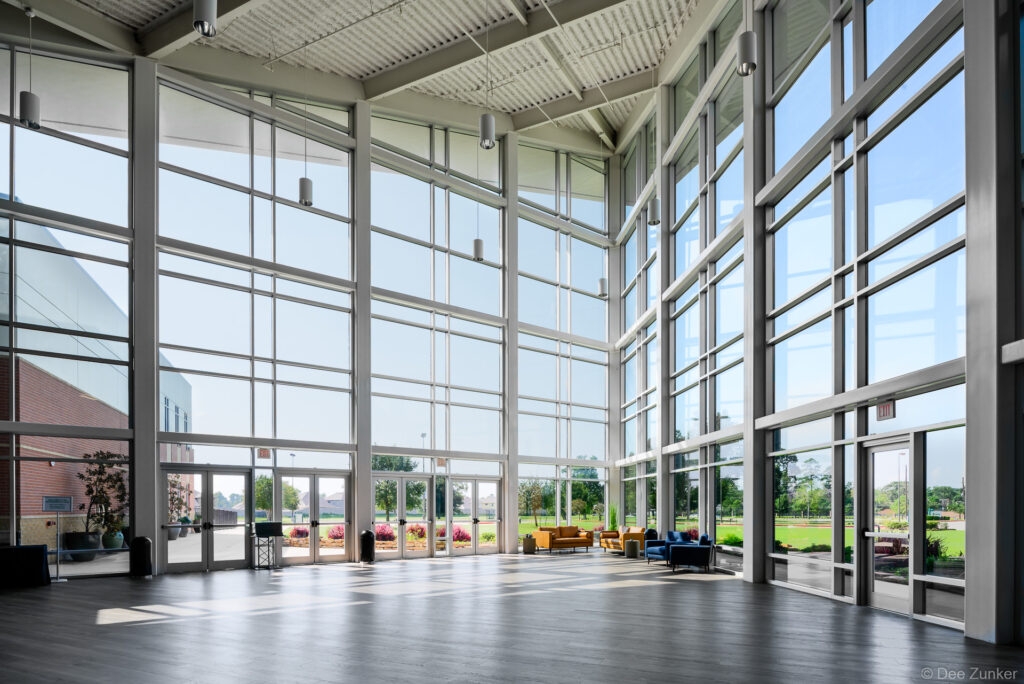 The spacious three-story atrium entrance of Faithbridge Church in Spring, TX, an example of modern institutional and religious architecture.