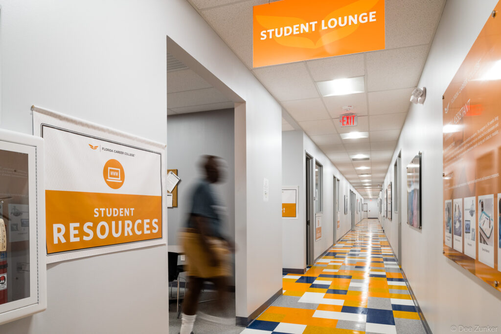 Architectural interior of a college building in southwest Houston, TX, featuring a hallway with a brightly colored institutional design.
