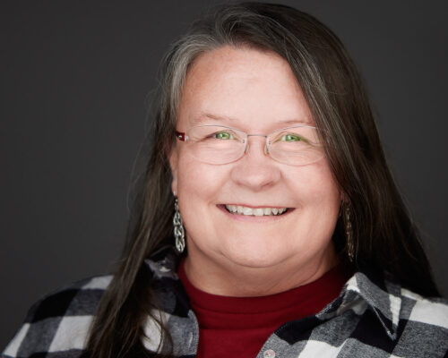 Professional Headshot of Commercial Photographer Dee Zunker in a white and black flannel shirt over a red shirt. Houston Commercial Architectural Photographer Dee Zunker 
