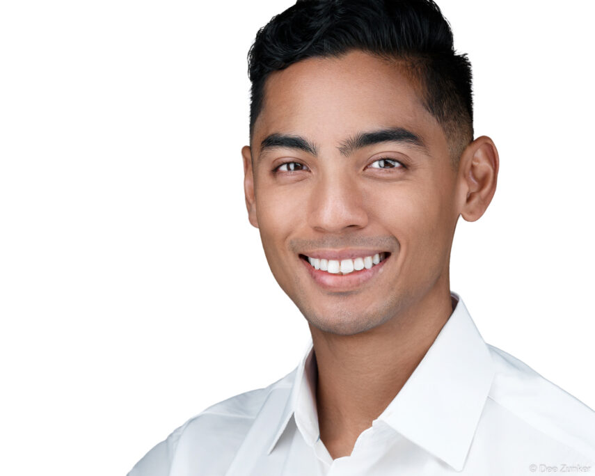 Smiling young man in white dress shirt, clean white background corporate headshot, professional staff portrait photography Houston TX.