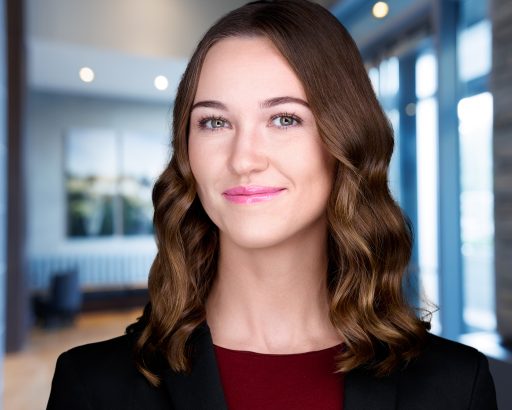Professional headshot with office background