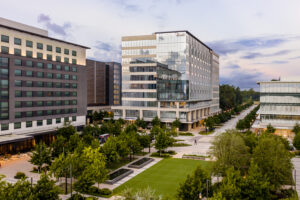 Elevated photo of the new ABS building showing reflections and the landscaped greenspace adjacent to the complex at dawn in the Woodlands TX 