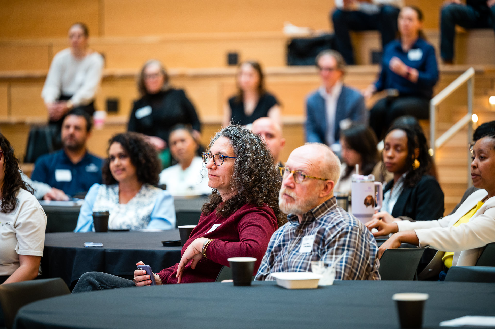 Conference attendees seated during panel session at Houston sustainability summit