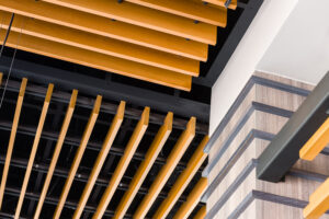 Product details of Rulon wood acoustical ceiling treatments within a newly renovated Gyu Kaku in The Heights Houston TX. 