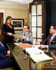 Branding photo showing lawyers at a conference table in Houston