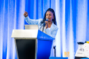 Conference photo of keynote speaker at summit in The Woodlands, TX