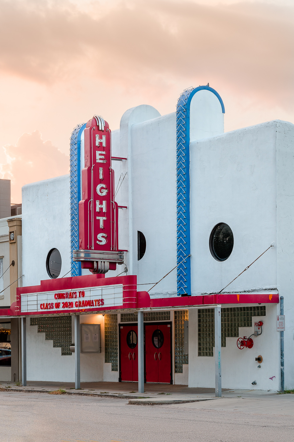 The freshly painted exterior and glowing marquee of the historic Heights Theater in Houston, Texas, photographed at dusk.