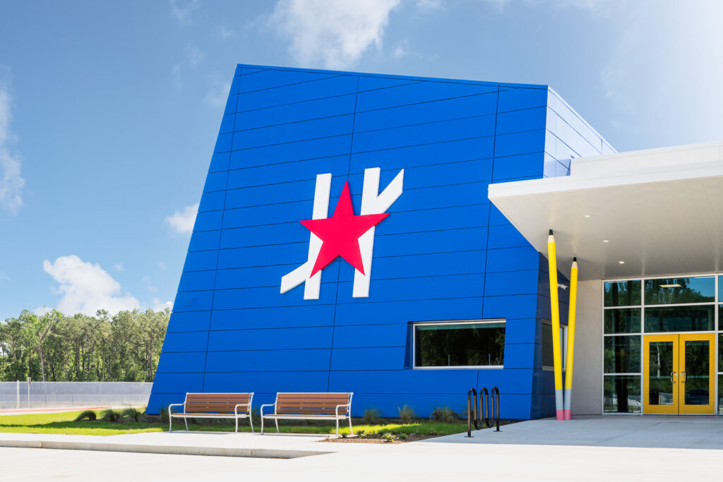 Modern outdoor benches, designed by Site Scapes, at the front entrance of Harmony School in Spring, Texas.