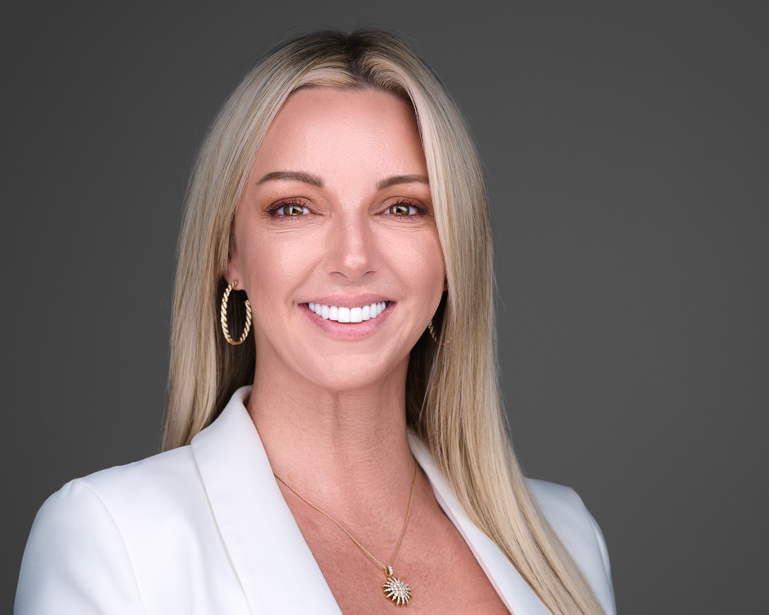Female executive Headshot on dark gray background