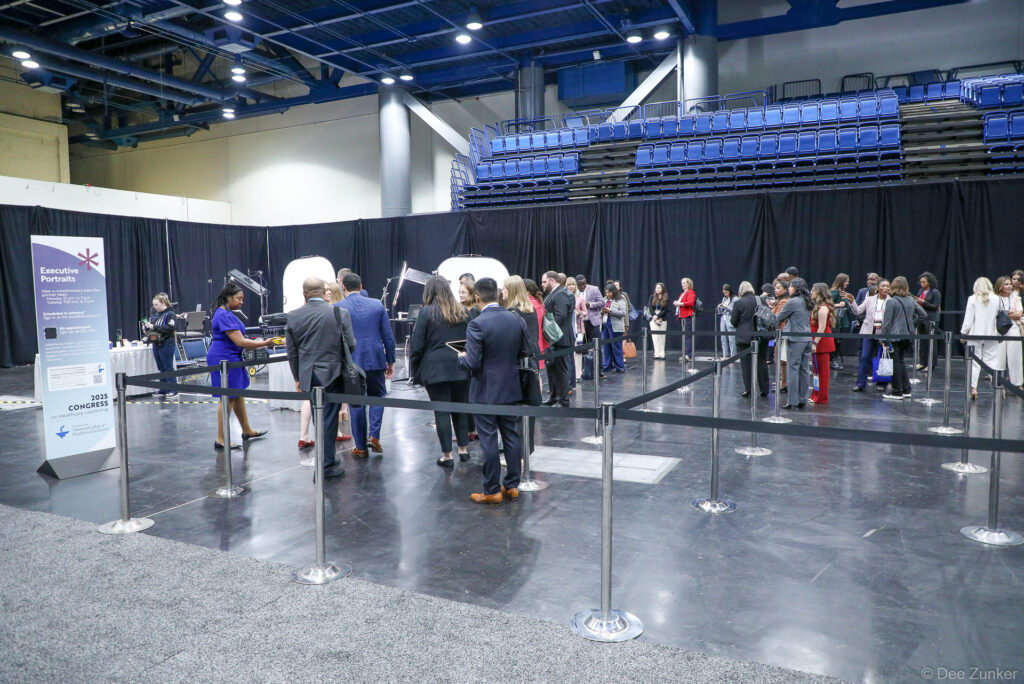 Professionals queue at an Executive Portraits booth during the ACHE Congress event, photographed by Dee Zunker Photography at a Houston convention venue.
