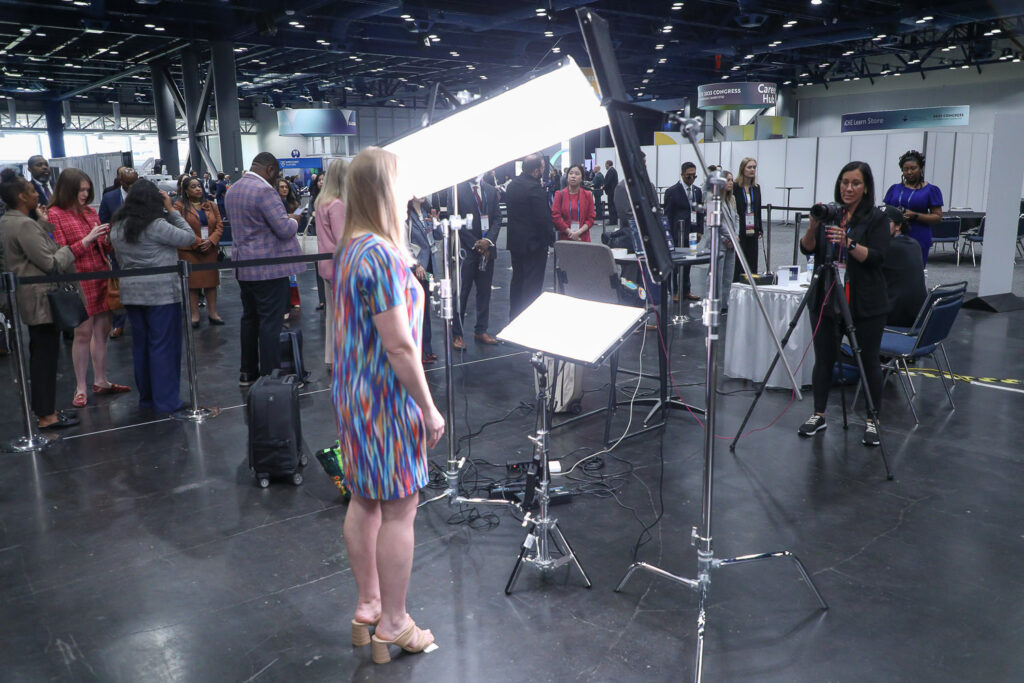 Giving Direction with lines behind at dual headshot station at george R Brown Convention Center in downtown Housotn, TX