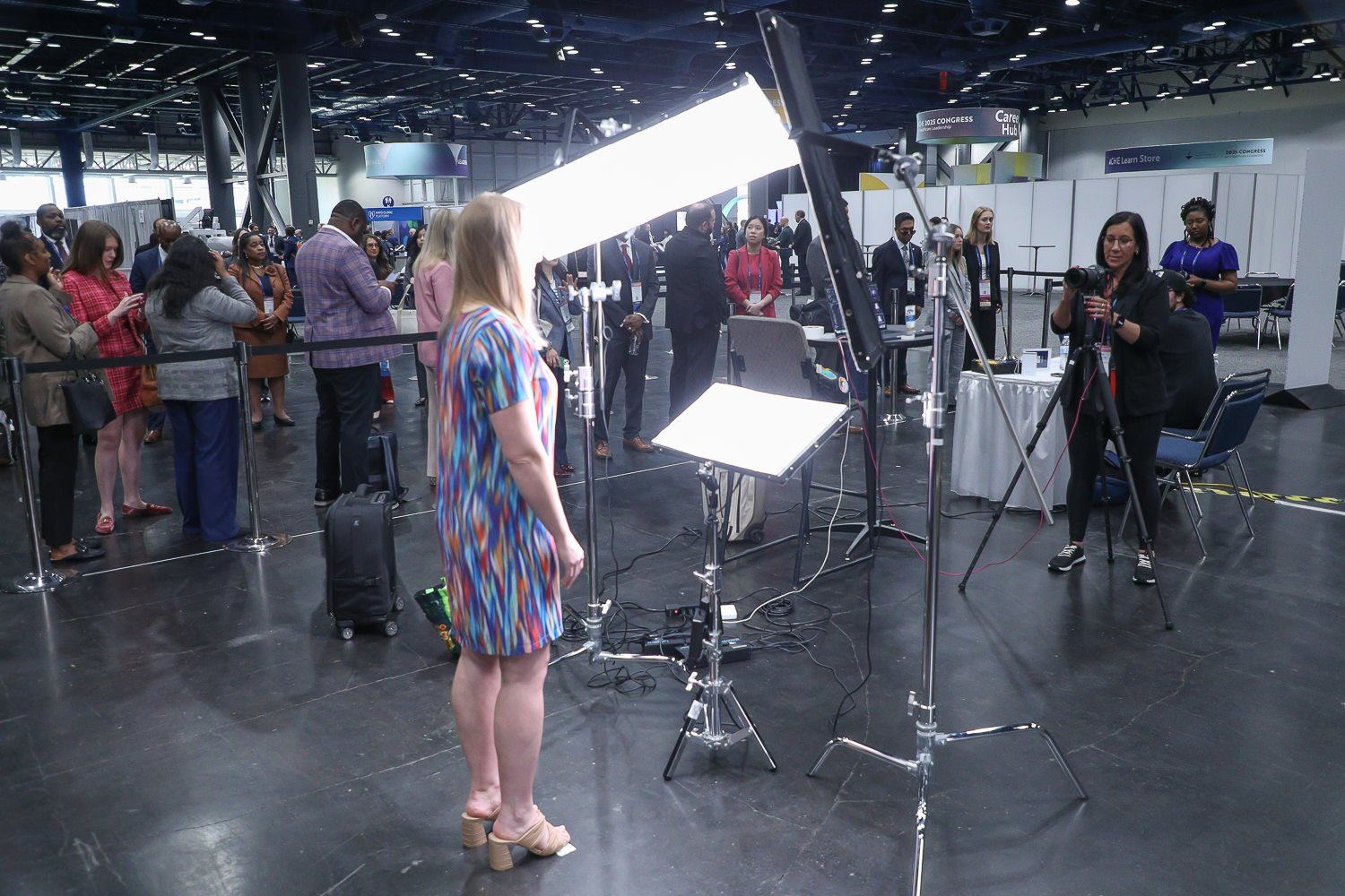 Giving Direction with lines behind at dual headshot station at george R Brown Convention Center in downtown Housotn, TX