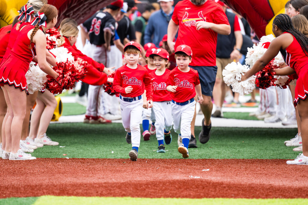 Phillises T-Ball players wlking with purpose as they enter the Opening Day ceremony for Bellaire Little League