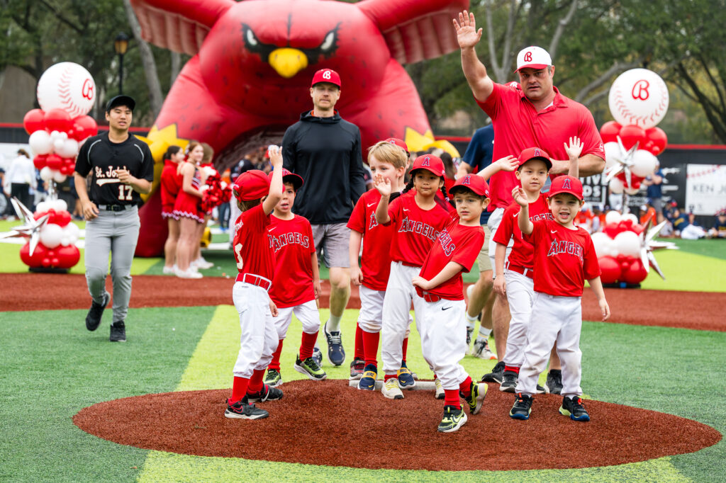 The Texas Disivion Angels wave as they get to teh pitcher's mound on opening day at weston field 2026
