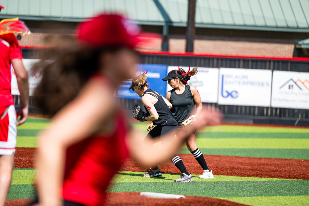 Mom's softball gamne action shot with play at second and batter running to first base