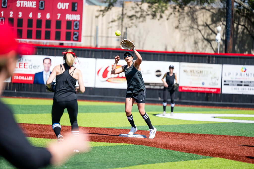 Moms softball player catching a ball during Bellaire Little League Opening Day