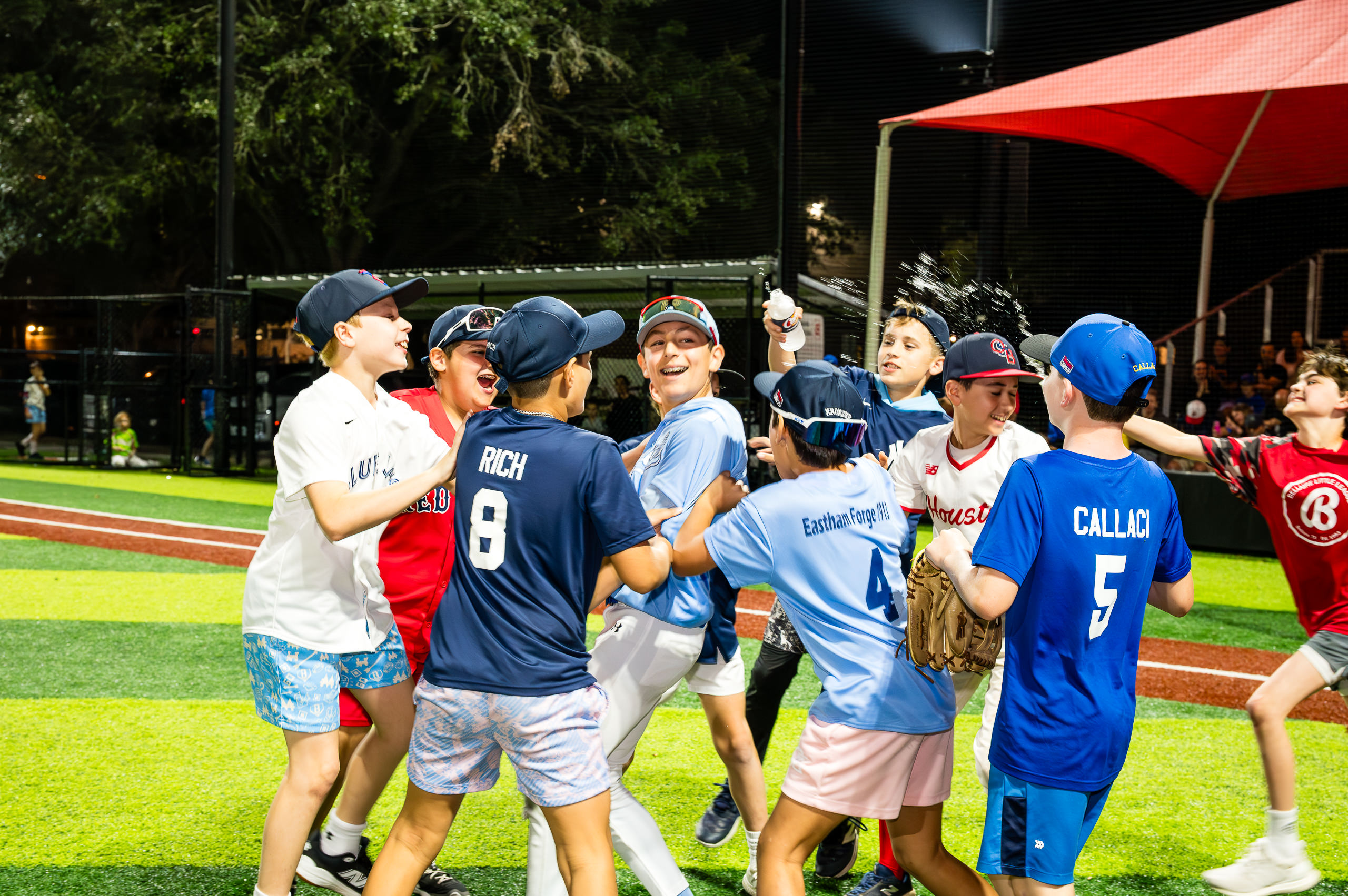 Players congratulate Joe Peryy after he wins the Home Run Derby during Bellaire Little League Opening Day February 28, 2026