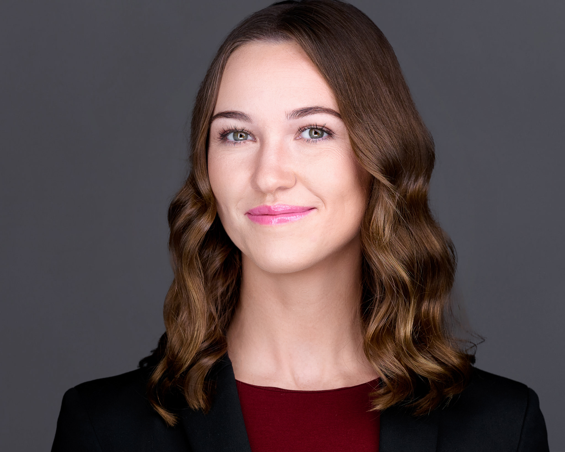 Female professional headshot on medium gray background