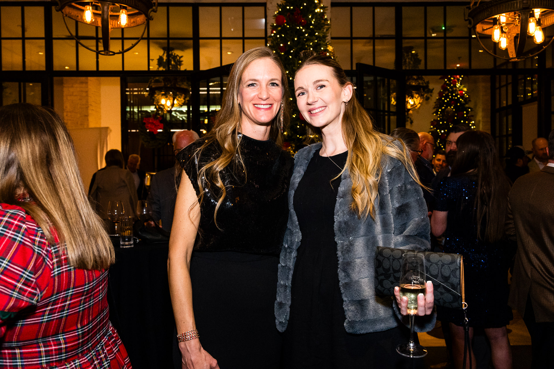 Guests at Houston corporate holiday party with festive lighting
