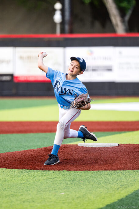 Young Rays pitcher winds up on the mound during a Bellaire Little League American League game at Weston or Tiras Field in Bellaire TX.