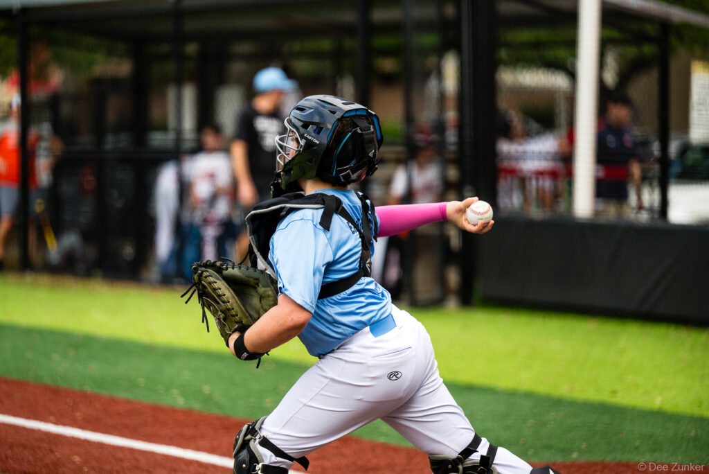 Bellaire Little League Rays catcher in full gear throws the ball during an American League game at Weston or Tiras Field in Bellaire TX.