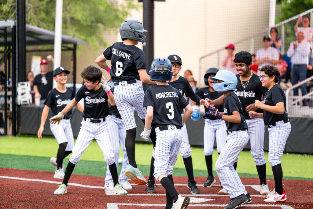 Southside White Sox youth players celebrate at home plate after a run scored during a Bellaire Little League American League game at Weston Field.