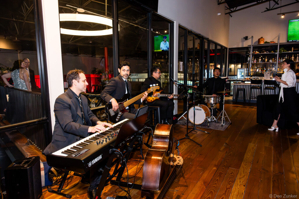 Jazz quartet with Yamaha keyboard, bass guitar, upright bass, and drums performs at the 40th Annual AIA Houston Design Gala at The Shop Club Houston.