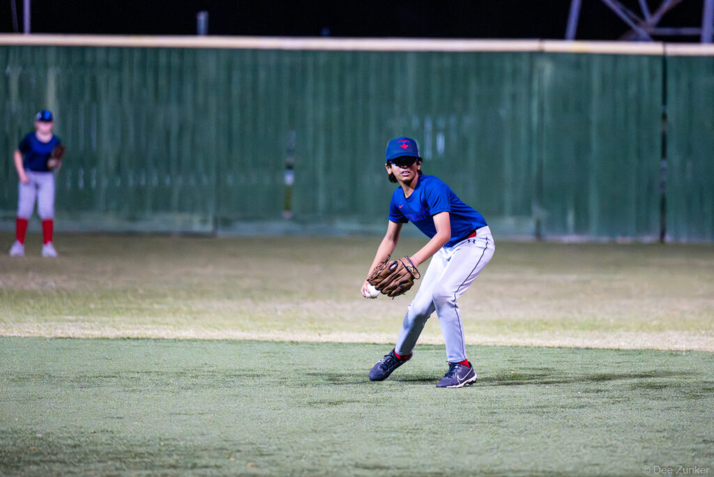 Young Blue Jays infielder fields a ground ball during a Bellaire Little League American League game at Weston or Tiras Field in Bellaire TX.