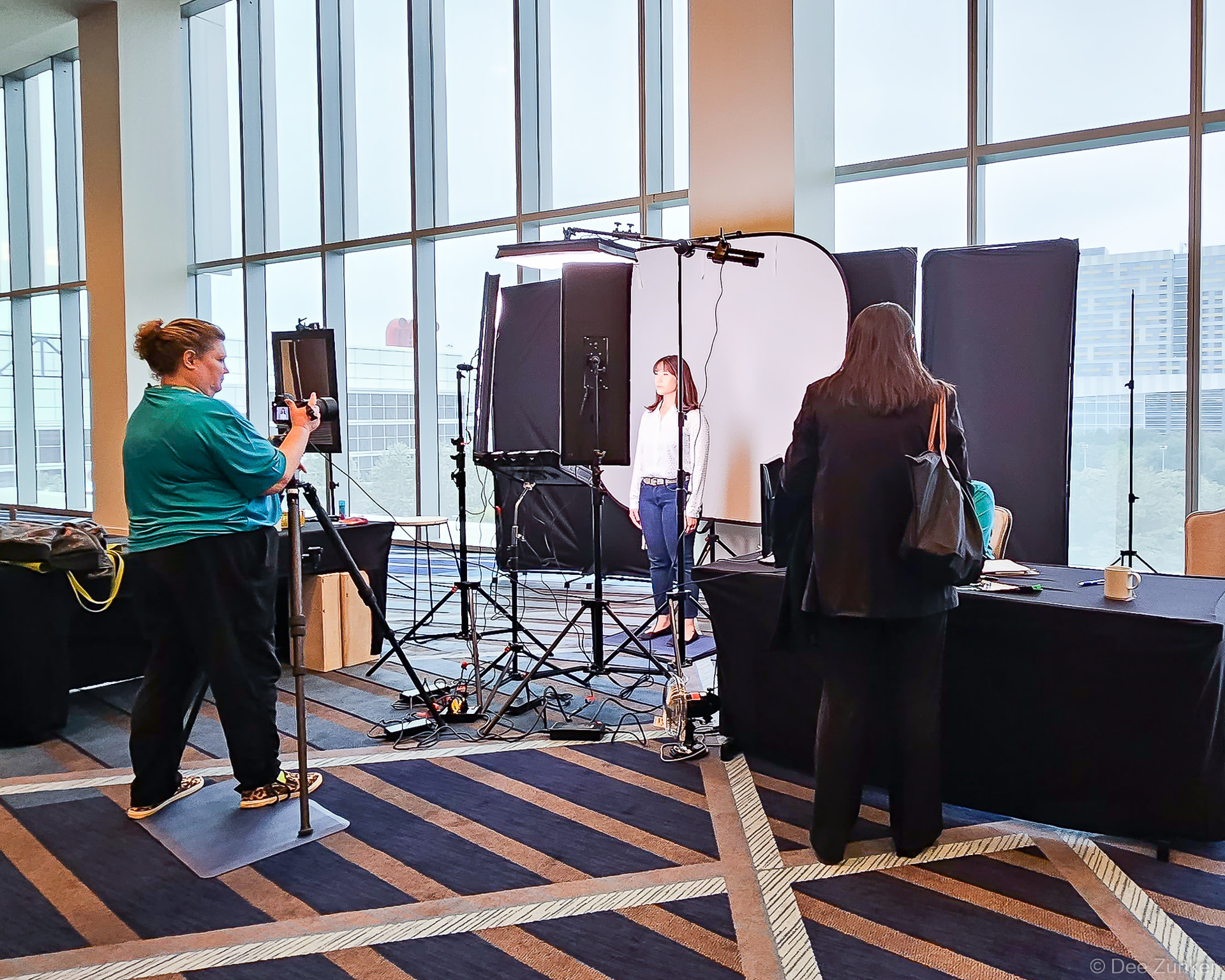 Photographer capturing a conference attendee portrait at an event headshot booth activation inside the Marriott Marquis Houston.