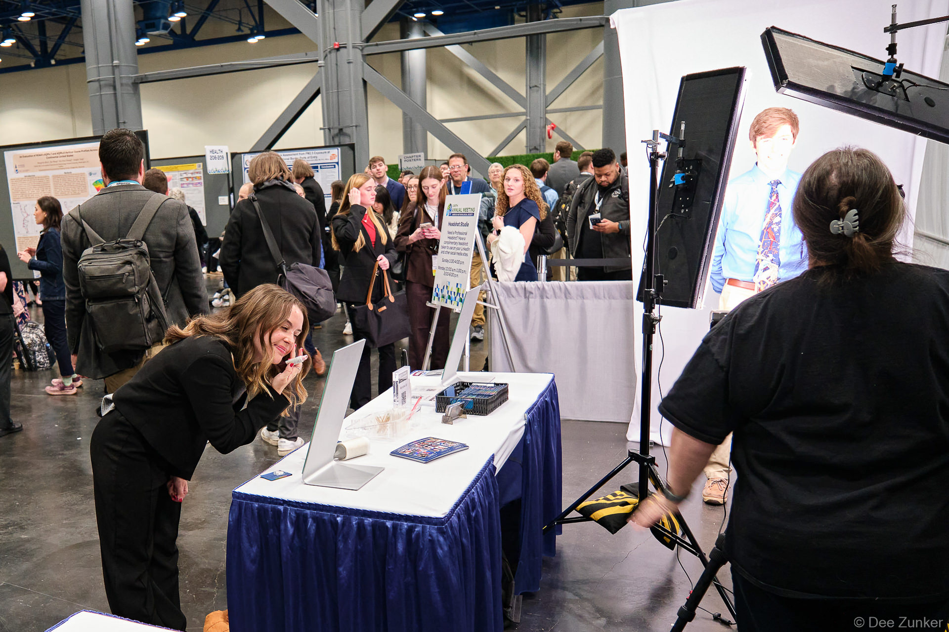Attendee leans toward preview monitor at event headshot booth activation inside George R. Brown Convention Center Houston Texas.