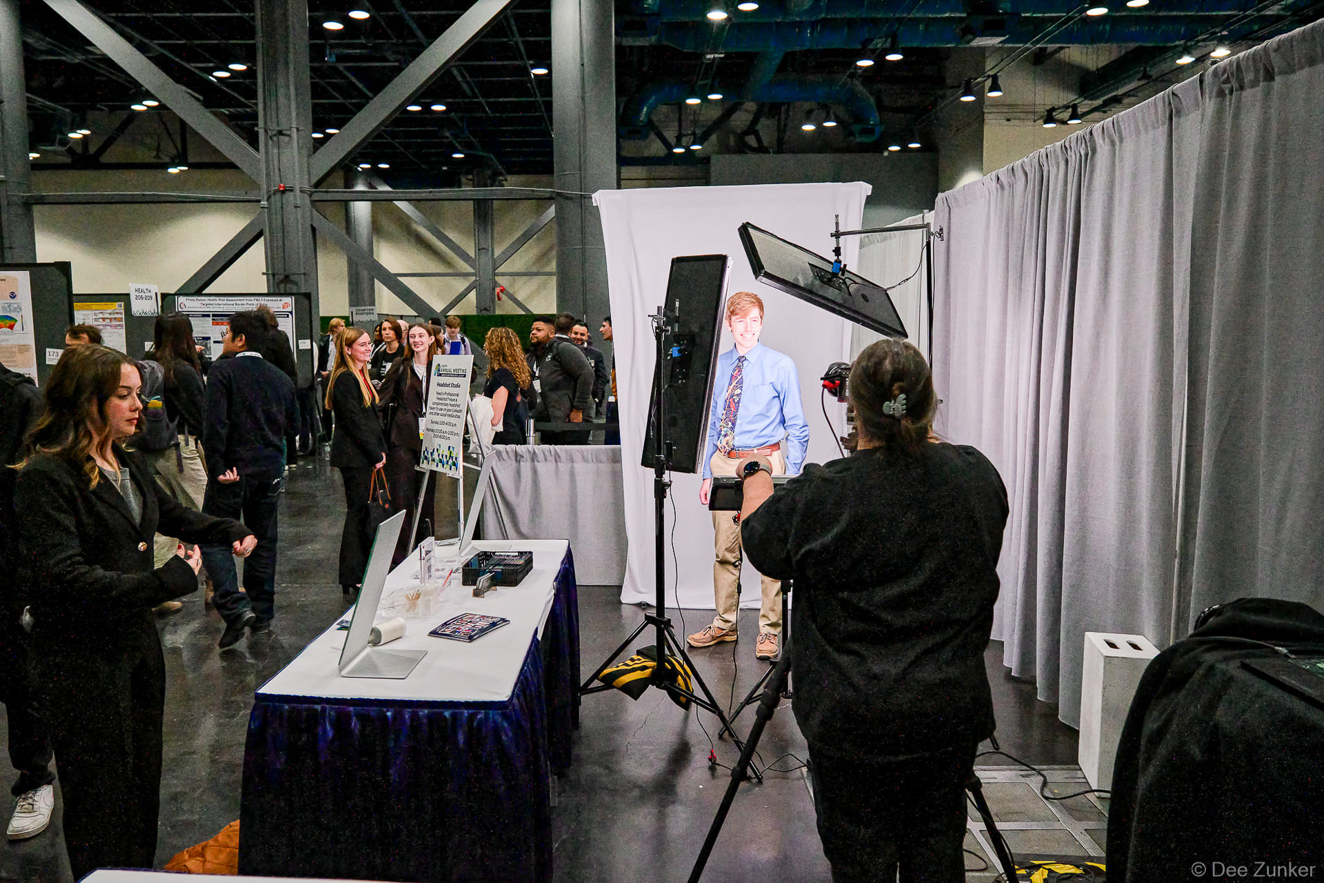 Photographer capturing attendee at event headshot booth inside George R. Brown Convention Center Houston trade show.