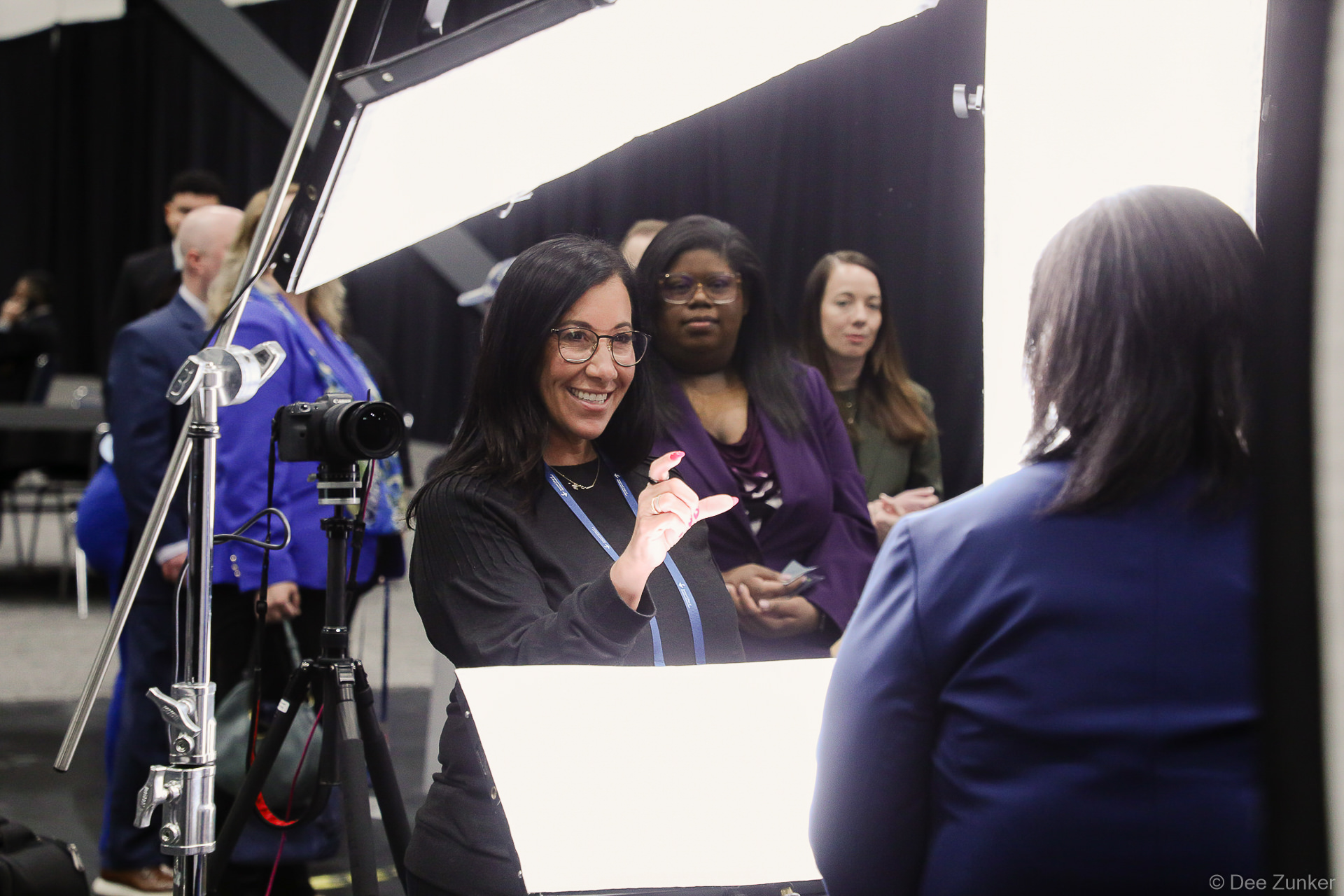 Photographer coaching an attendee on posing at an event headshot booth activation at George R. Brown Convention Center Houston