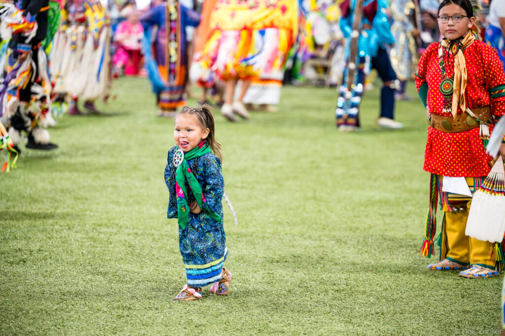 Young girl in beaded blue regalia dancing at Alabama-Coushatta 56th Annual Powwow Grand Entry, Livingston, Texas