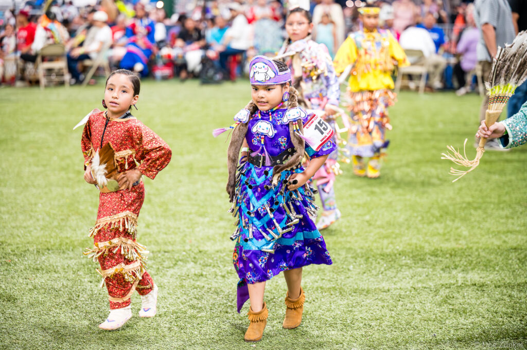 Native American children in traditional regalia dance at the Alabama-Coushatta 56th Annual Powwow, Livingston, Texas, June 2025.