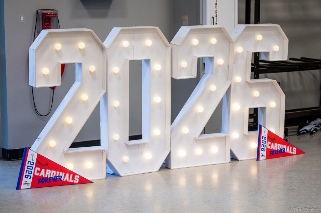 Illuminated marquee letters spelling 2026 with Cardinals Forever pennants at Horn Elementary 5th grade graduation in Bellaire TX