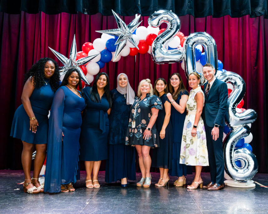 Group of teachers and staff posing on stage at Horn Elementary 5th grade graduation celebration in Bellaire TX 2026