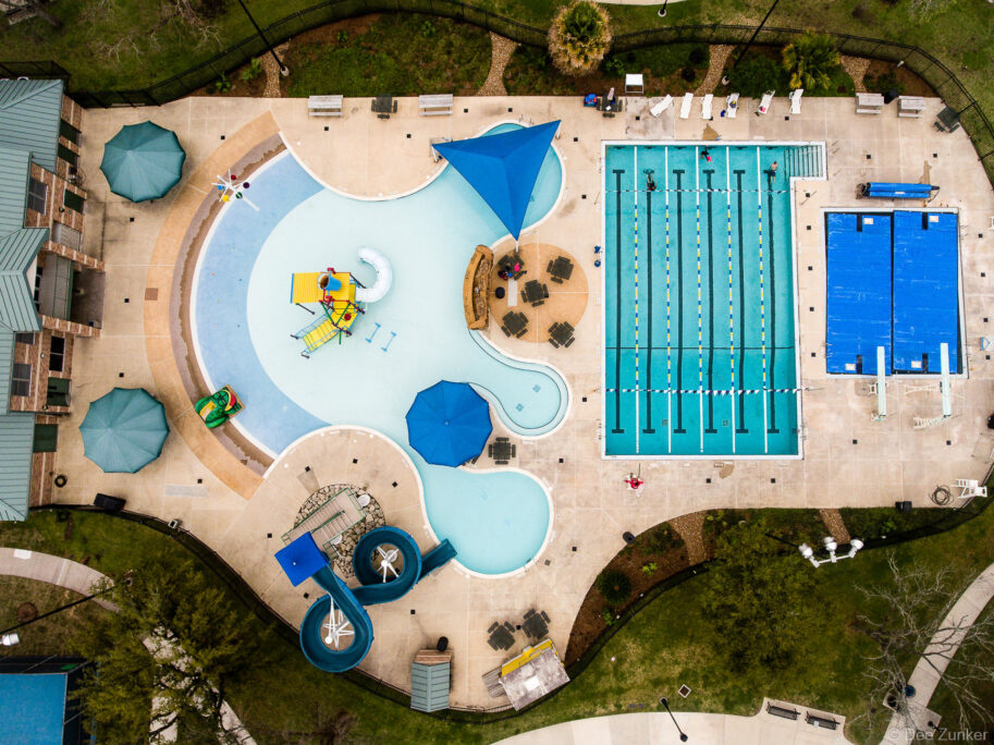 Overhead drone photo of the community pool in Bellaire, TX. The swimming lanes and pool layout are seen from a top-down perspective.