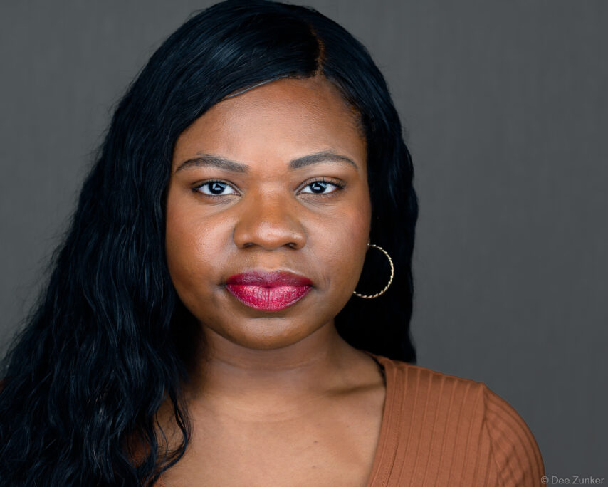 Professional studio branding headshot of a woman against a gray background, ideal for small business owners in Houston