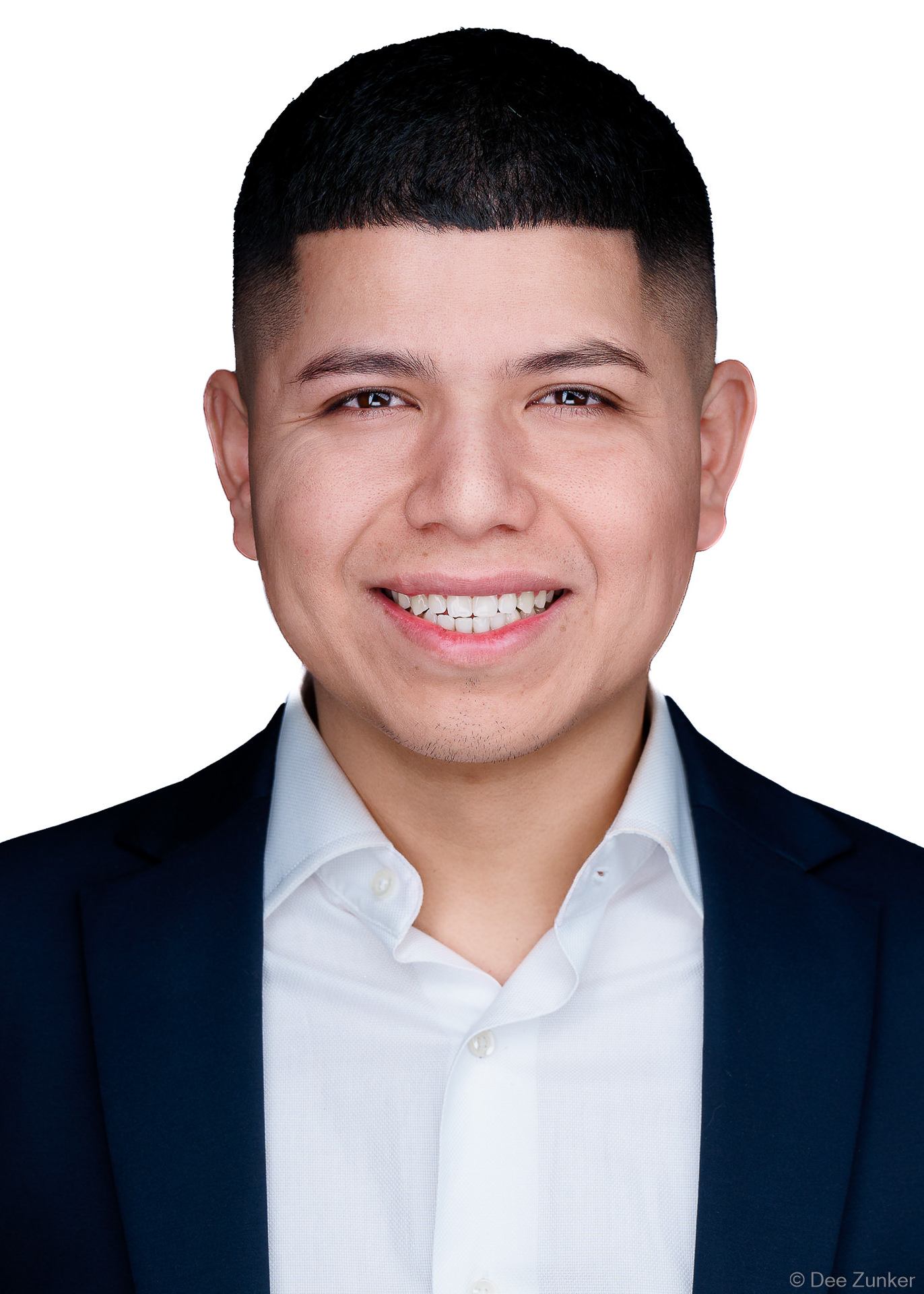 Young male medical residency applicant in navy blazer and white shirt, professional ERAS headshot photographed near Texas Medical Center, Houston TX with white background.